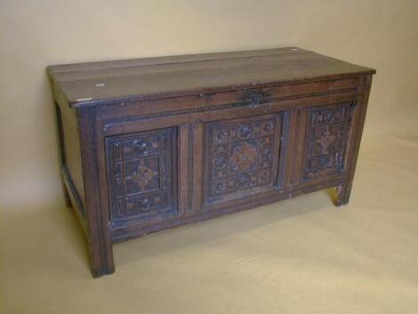 A 17thC oak three panel coffer with later top