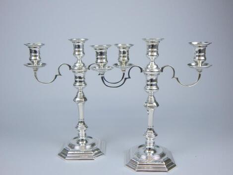 A pair of silver three branch candelabra