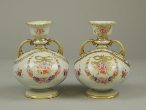 A pair of Continental porcelain two handled vases