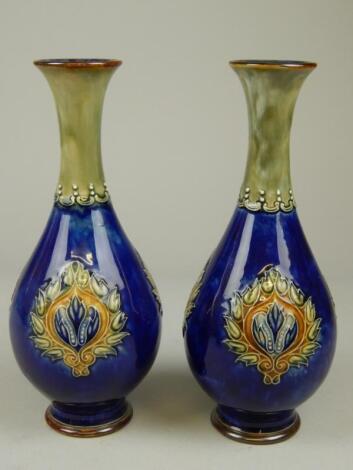 A pair of Royal Doulton stoneware bottle shaped vases