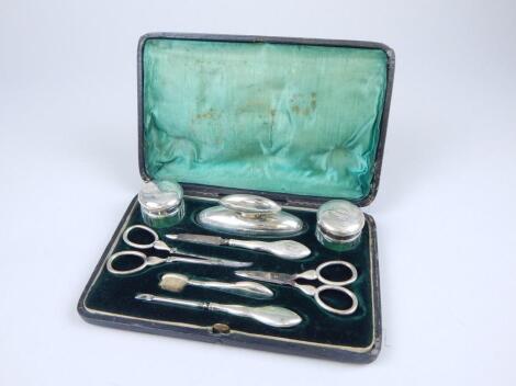 An Edwardian silver mounted manicure set