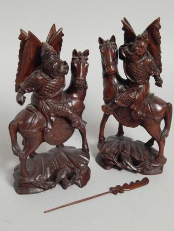 A pair of Oriental carved hardwood figures