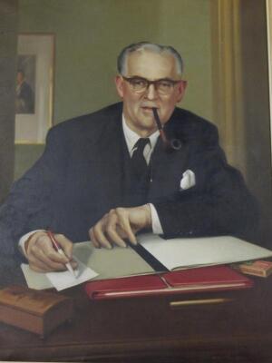 John R Townsend (1930-2014). Portrait of a gentleman sitting at his desk
