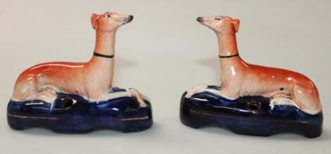 A pair of Staffordshire pottery greyhound ink stands