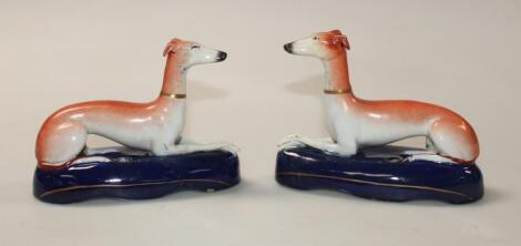 A pair of Staffordshire pottery greyhound ink stands