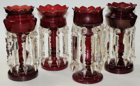 A near matching pair of Victorian ruby glass lustres