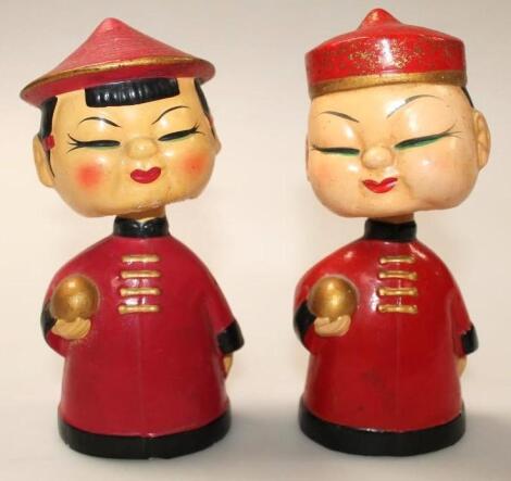 A pair of 20thC papier mache nodding head figures