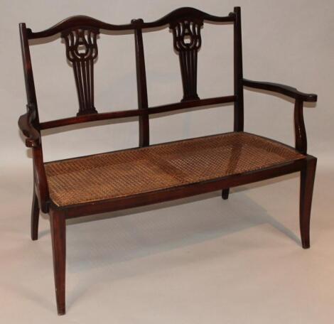 An Edwardian mahogany double backed settee