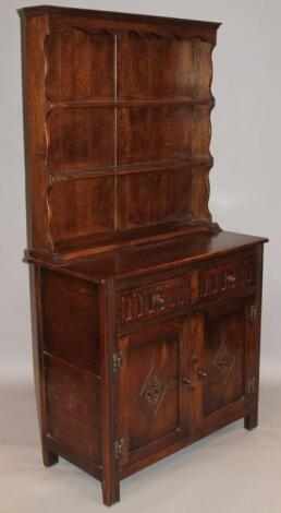 A 20thC Ercol style oak and elm finish dresser