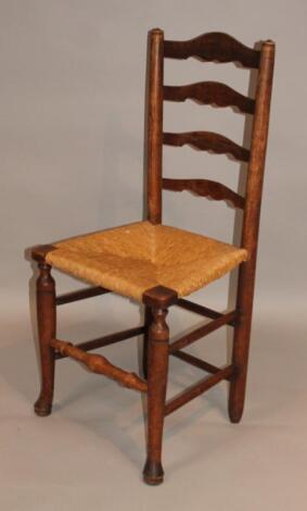 An 18thC ash ladderback chair