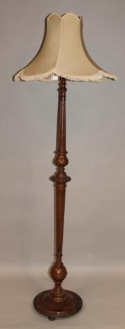 A 20thC mahogany stained standard lamp