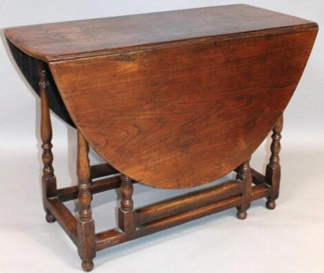 An early 20thC oak Jacobean design gateleg drop leaf table