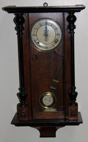 An early 20thC walnut and ebonised wall clock