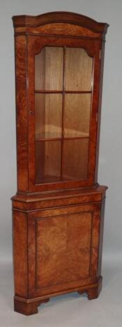 A 20thC Queen Anne style walnut veneered corner cabinet