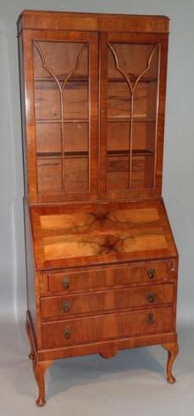 A 20thC walnut finish bureau bookcase