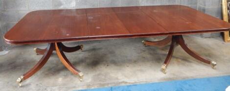 A Regency style mahogany twin pedestal extending dining table