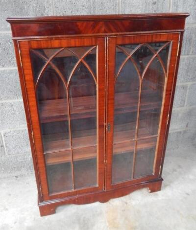 A 20thC flame mahogany finish free standing bookcase