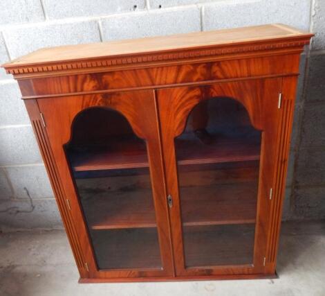 A 20thC flame mahogany finish bookcase top