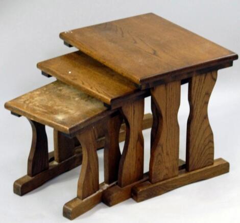 A nest of three plain oak rectangular coffee tables.