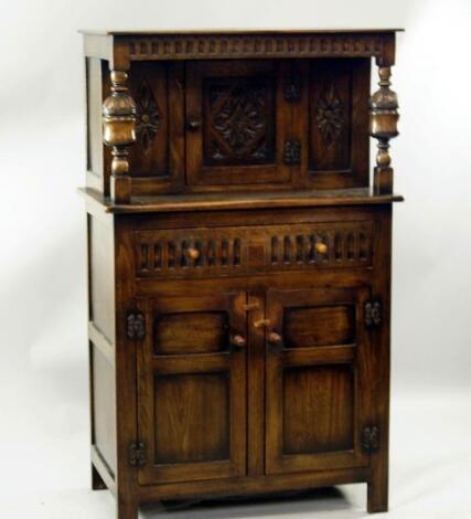 A small reproduction oak court style cupboard