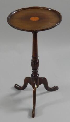 An inlaid mahogany tripod wine table.