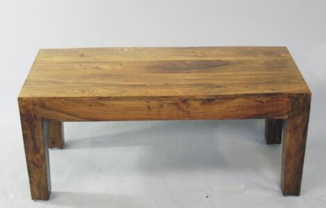 A rectangular hardwood coffee table