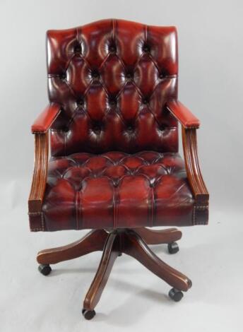 A reproduction mahogany swivel chair