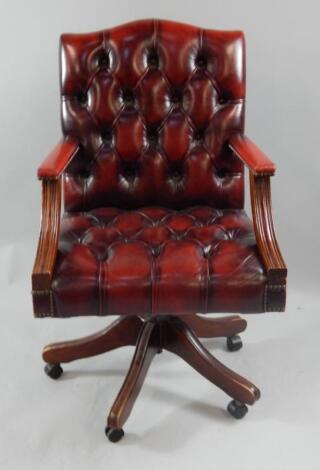 A reproduction mahogany swivel chair