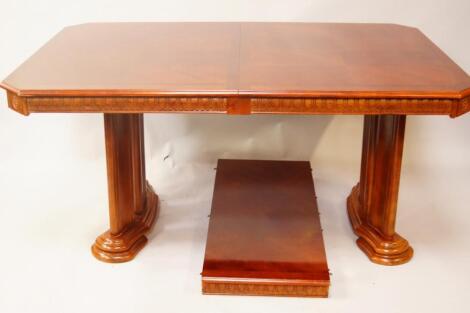 A mahogany finished extending dining table