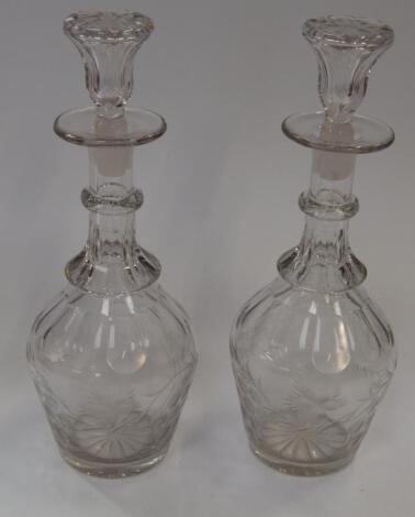 A pair of slice cut mallet shaped decanters