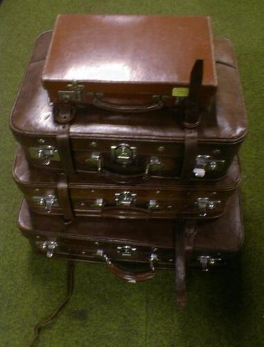 A graduated set of three leather suitcases