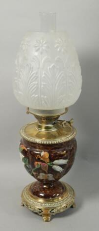 A late Victorian ceramic and brass oil lamp