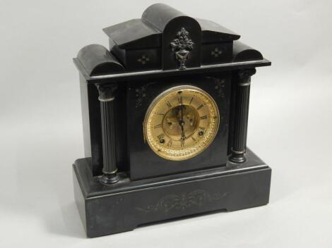 A late 19thC French black marble and metal timepiece