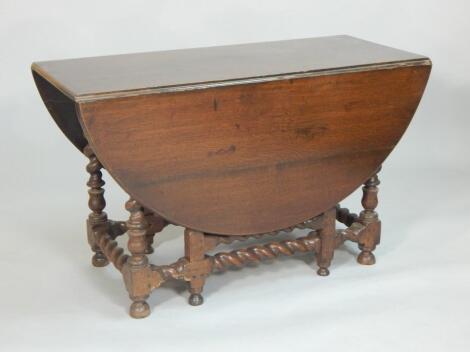 An 18thC oak oval gate leg table