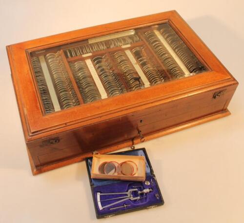 An early 20thC mahogany opticians tester lens set