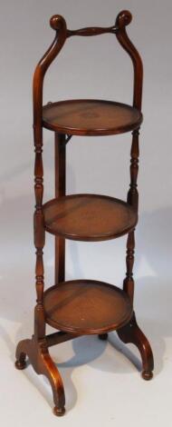 A mid-20thC mahogany three tier cake stand