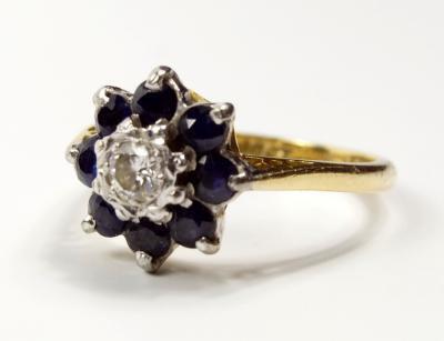 A sapphire and diamond cluster dress ring