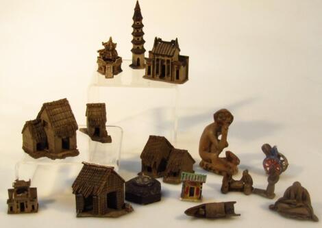 An unusual collection of oriental hard baked stoneware miniature buildings