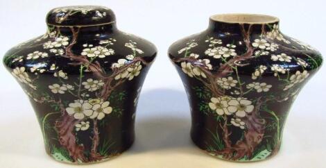 A pair of famille noir earthenware vases