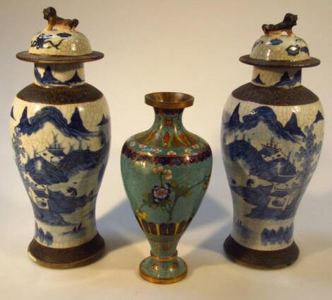 A pair of early 20thC Chinese pottery blue and white vases