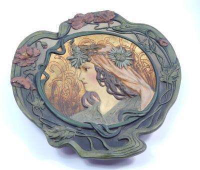 A Continental Art Nouveau style painted terracotta plaque