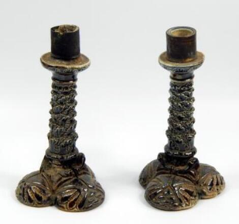 A pair of Martin Brothers candlesticks