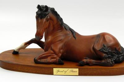 A Beswick matt glazed seated horse