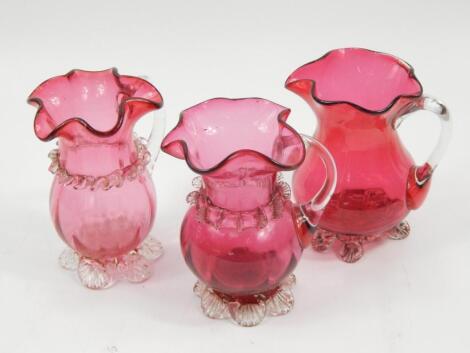 Three Victorian cranberry tinted jugs