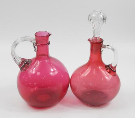 Two Victorian cranberry tinted mallet shaped spirit decanters