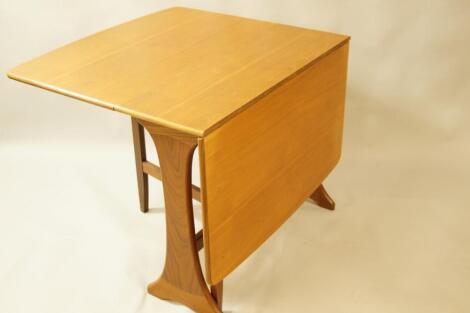 A 1970's teak dropleaf dining table