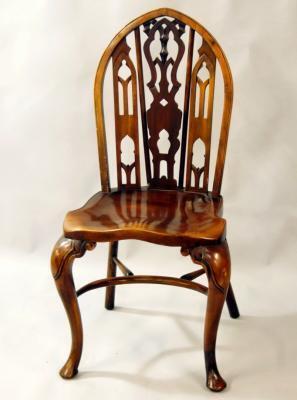 An 18thC style yew finish gothic Windsor chair