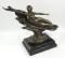 After Charles Couchet. A 20thC Talos Gallery bronzed figure of a reclining lady scantily clad on a s