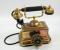 A brass finish vintage telephone.