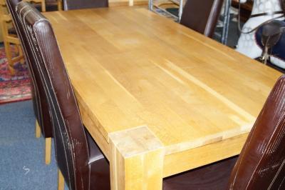 A modern oak dining table and six brown leather effect high back dining chairs